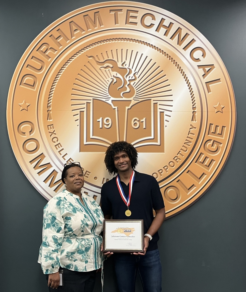 Jeferson Gomez Gonzalez accepting the Academic Excellence Award from Durham Tech VP Kara Battle