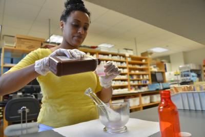 pharmacy technology student mixes a liquid prescription in lab