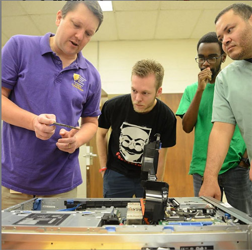 Instructor shows students internal components of a computer