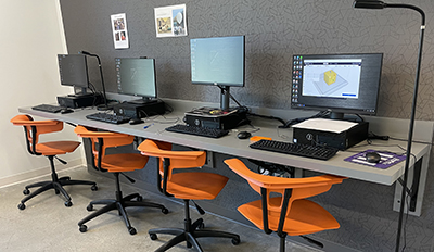 four computers lined up side by side 