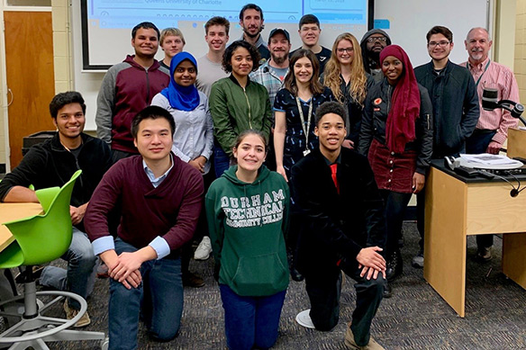 students pose in group photo in a classroom