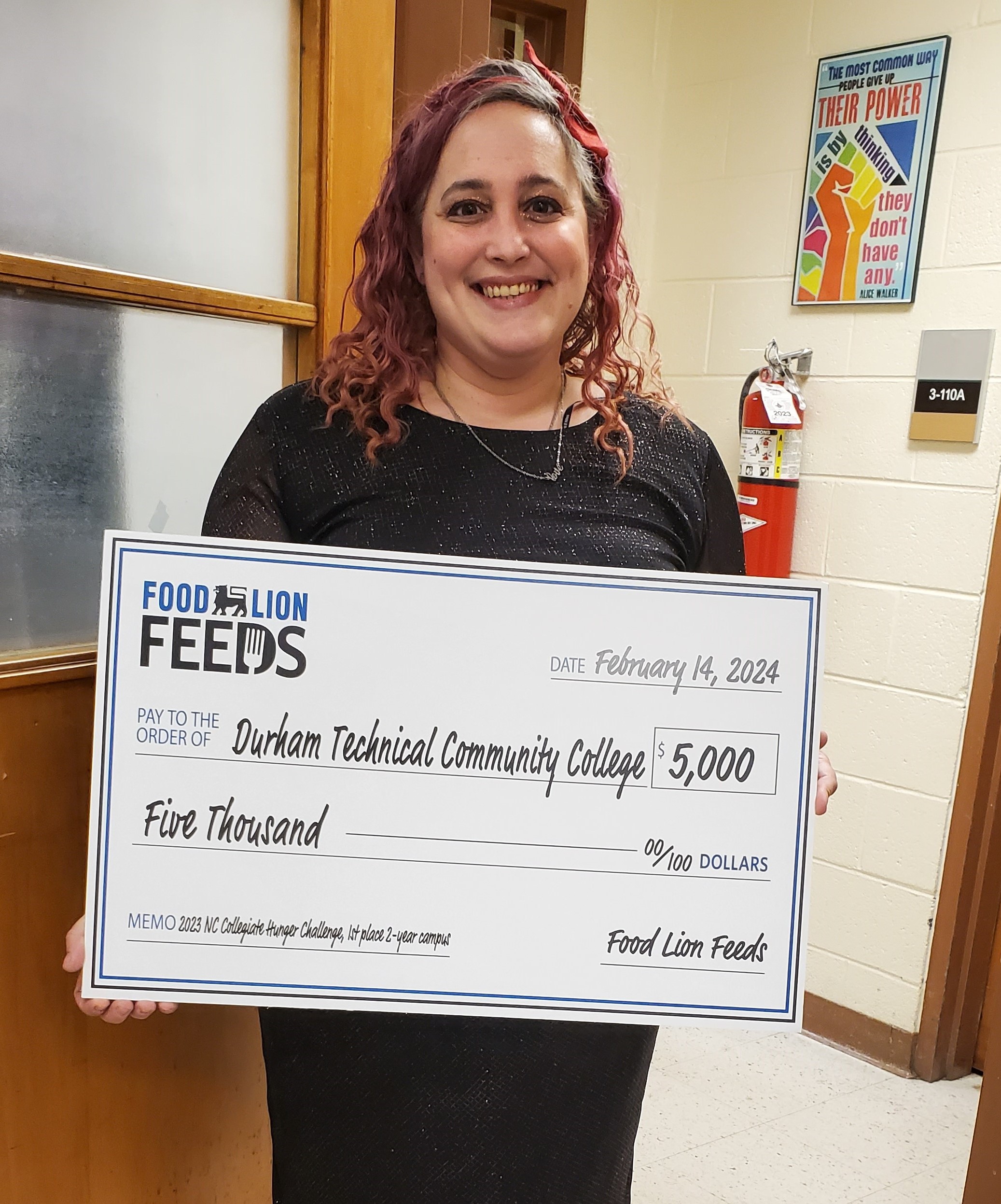Jessica Zettlemoyer holds a big check for $5,000