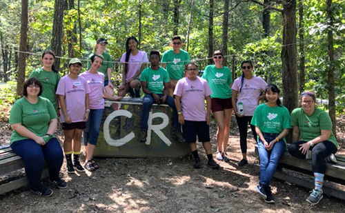 Durham Tech volunteers pose in a woodland setting