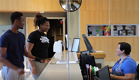 students report to the Welcome Desk to ask for assistance