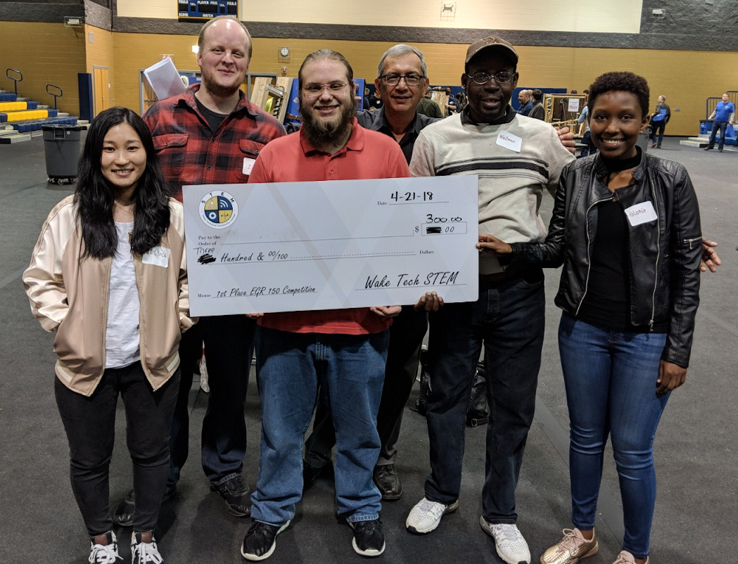 group of engineering students holding check