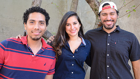 three dental students who traveled to Honduras pose with arms over each others shoulders
