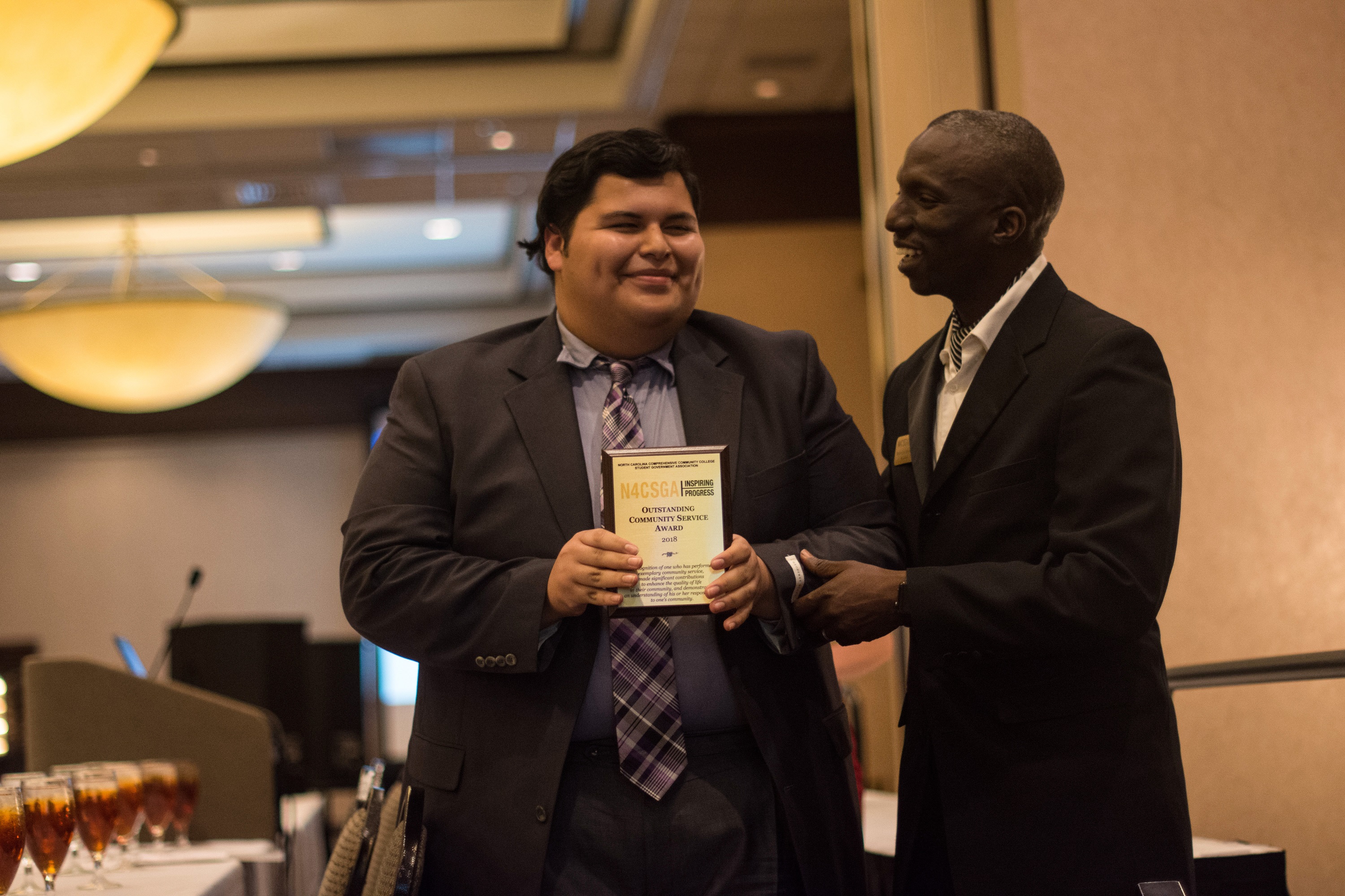 Student, Michael, accepting award at ceremony