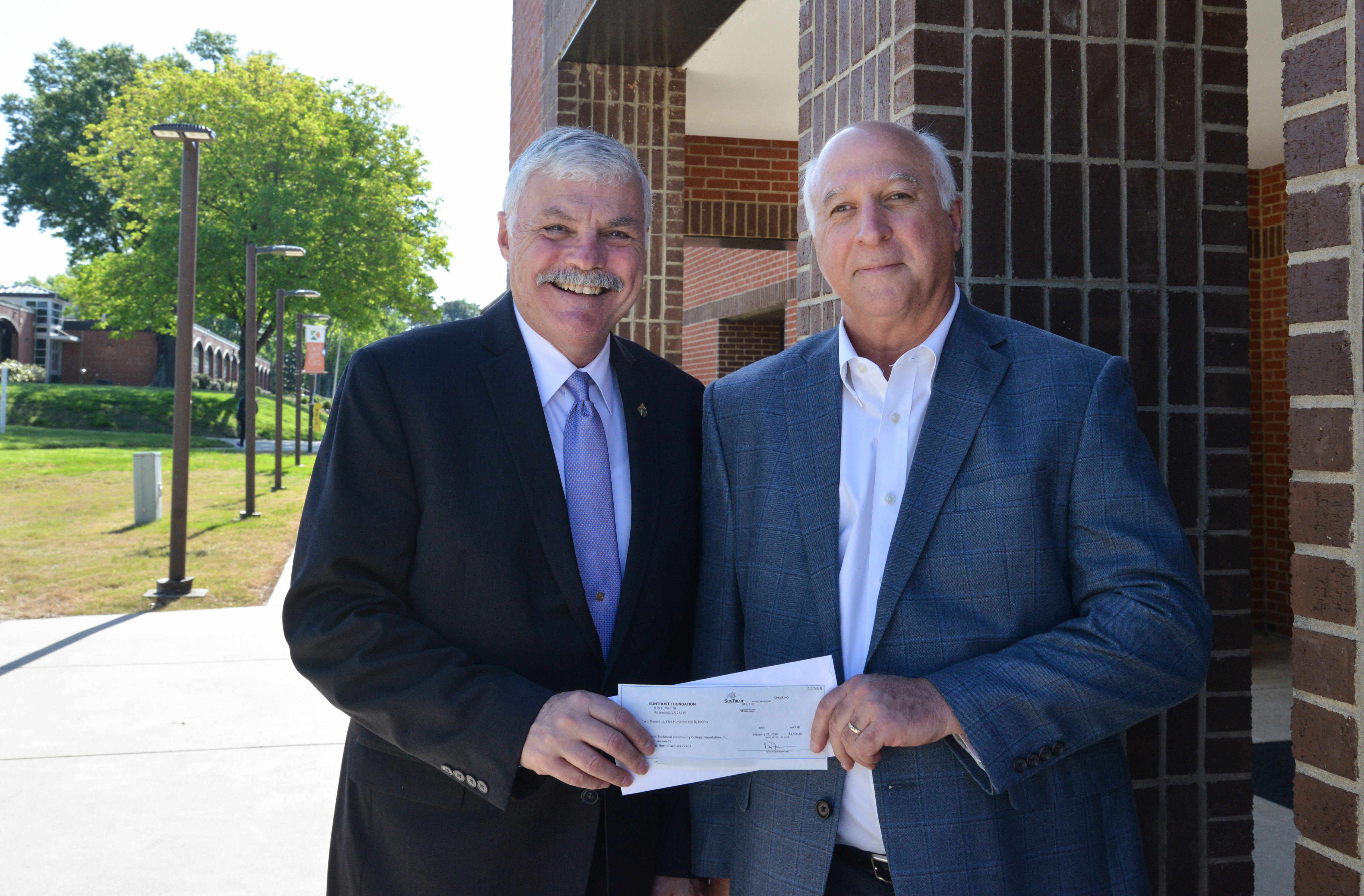 Bill Ingram and Jeff Stoddard holding check