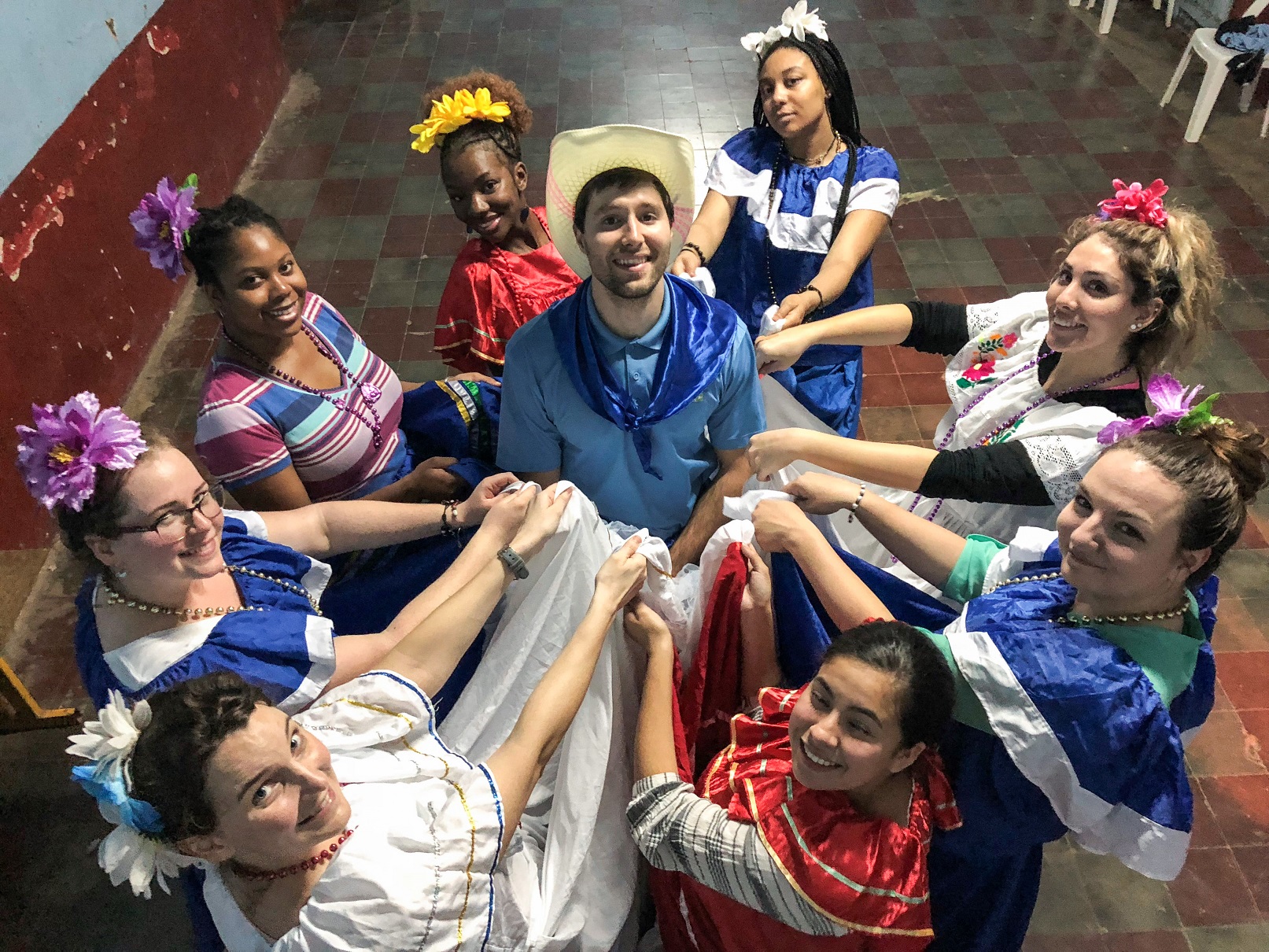 photo of students standing in circle dancing in Nicaraguan clothing