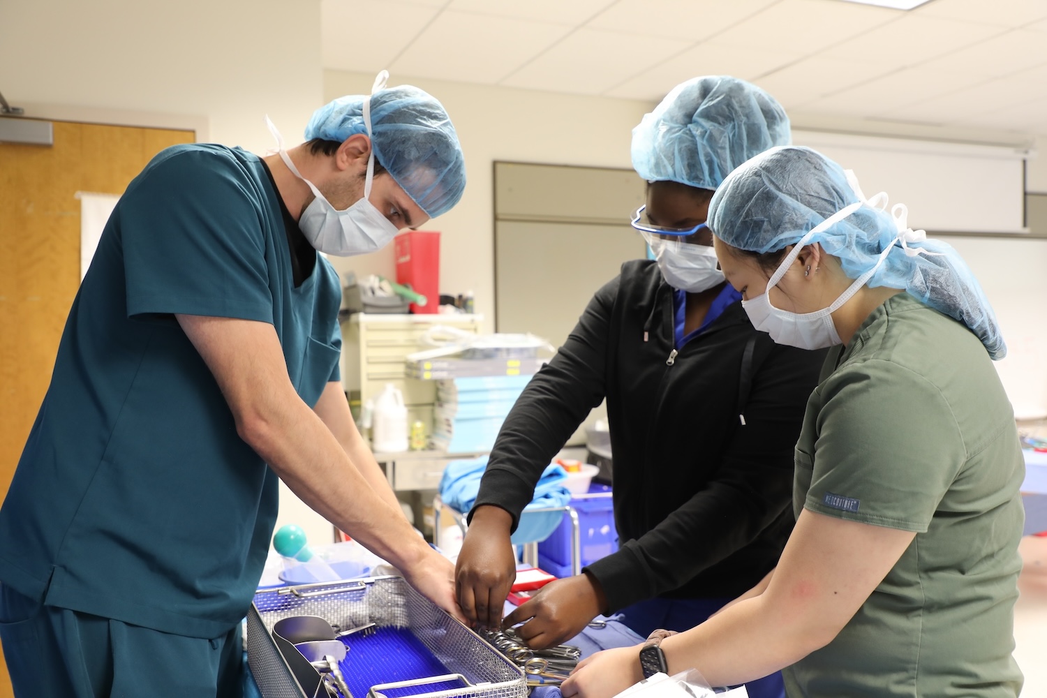 Students practicing the use of medical equipment