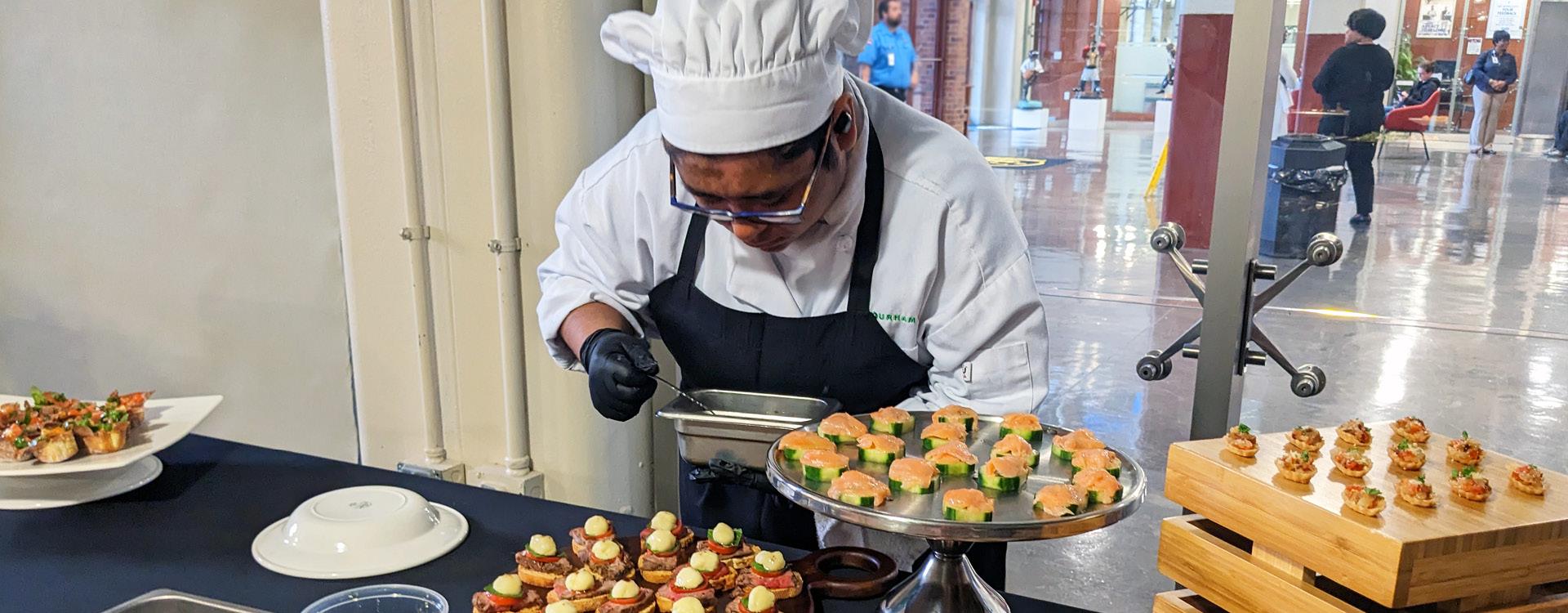 culinary student puts final touches on an appetizer display