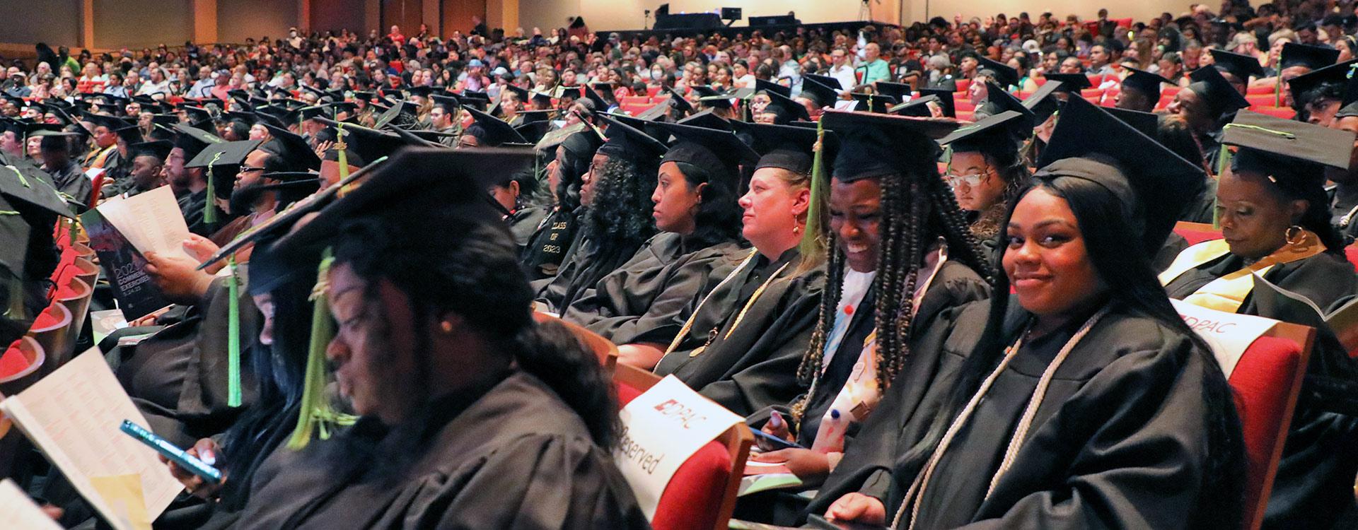 audience of graduates wearing regalia at commencement ceremony