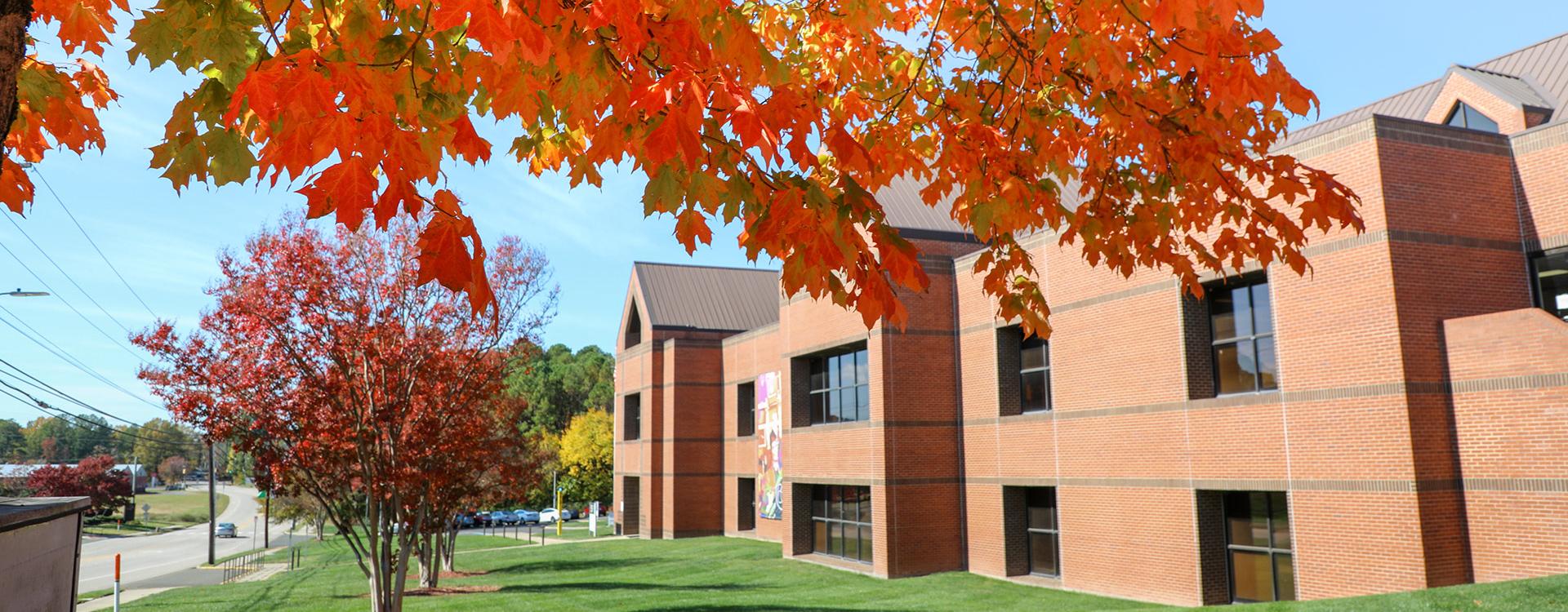 Educational Resources Center brick building with a tree with fall leaves in front