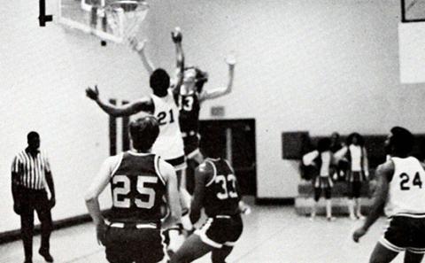 basketball players jump for the rebound under the hoop
