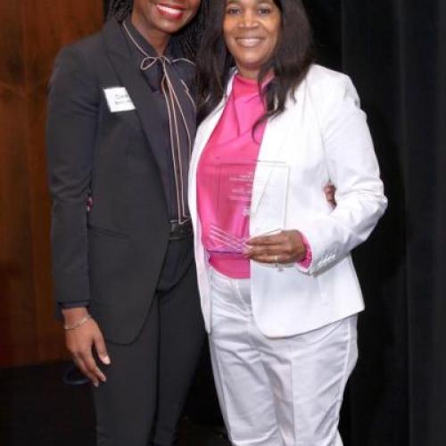 Pebbles Lucas (right) accepts the Child Care Services Association 2024 Mary Y. Bridgers Early Childhood Teacher Award.