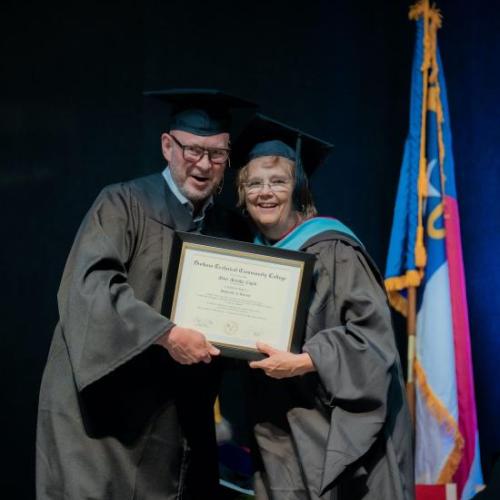 Mary Marsha Cupitt receives her honorary degree from Board of Trustees member Geoff Durham.