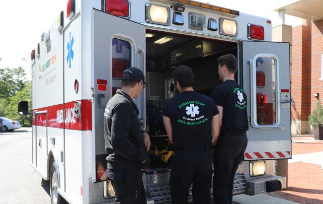 EMS students taking a stretcher out of an ambulance