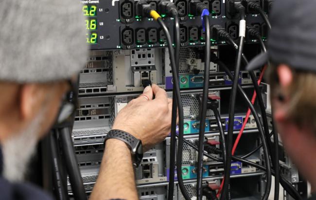 teacher and student working together on a server rack