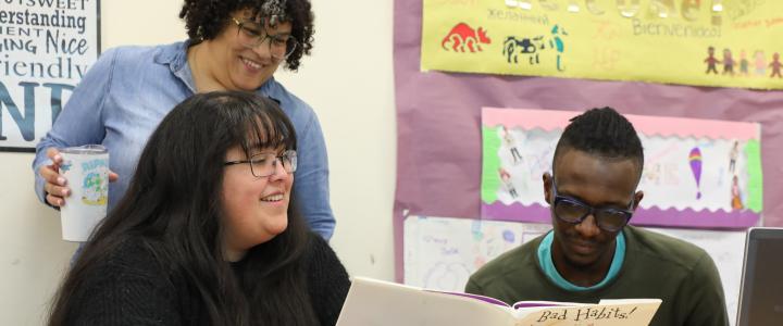Students reading a children's story in a classroom teaching Early Childhood Education