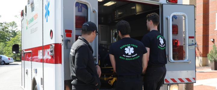 EMS students taking a stretcher out of an ambulance