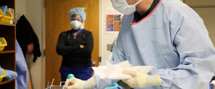 student preparing sterilized equipment for a surgical operation