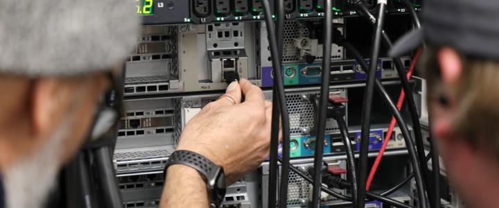 teacher and student working together on a server rack