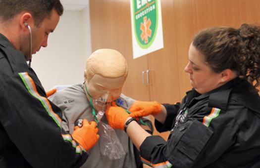 Two Emergency Medical Science students use a stethoscope on a training manikin during a class at the Durham Tech Orange County Campus.