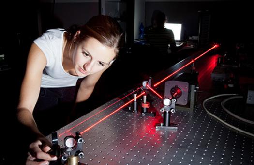 physics student is adjusting a red laser