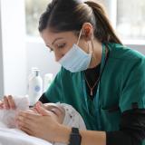 Esthetics technology student massages a client's face during an esthetics appointment