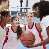 female basketball coach planning strategy with team members
