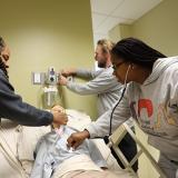 respiratory students practice patient care in a health lab setting