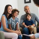 family sitting and talking with a social services professional