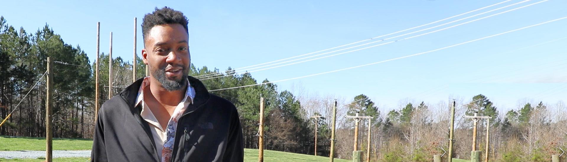 student stands in Durham Tech pole yard for electric line technician program