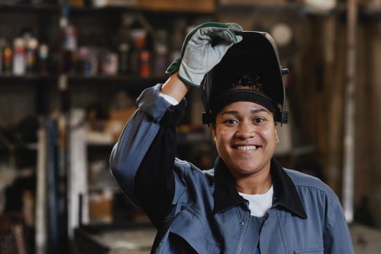 young woman wearing a welder's mask